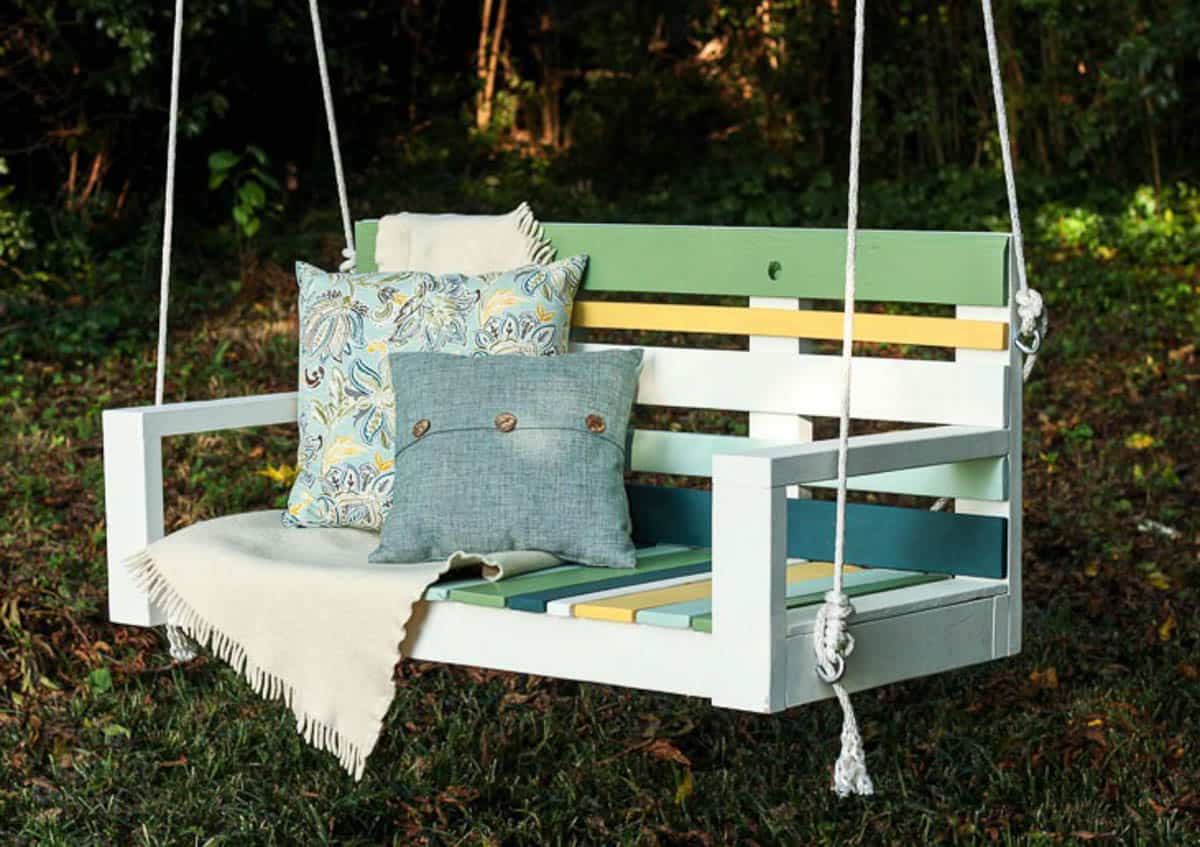 porch swing with pallet wood slats painted green and yellow