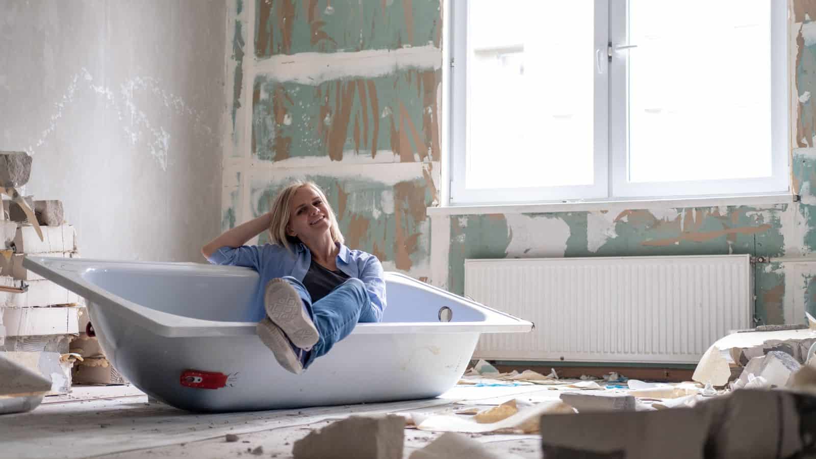 woman sitting in uninstalled bathtub