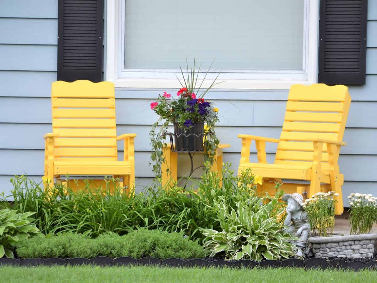 front yard with yellow chairs and garden area