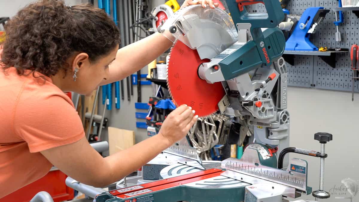 woman checking the blade of the miter saw