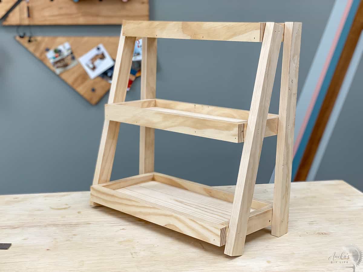 Completed wooden DIY tiered organizer on the workbench