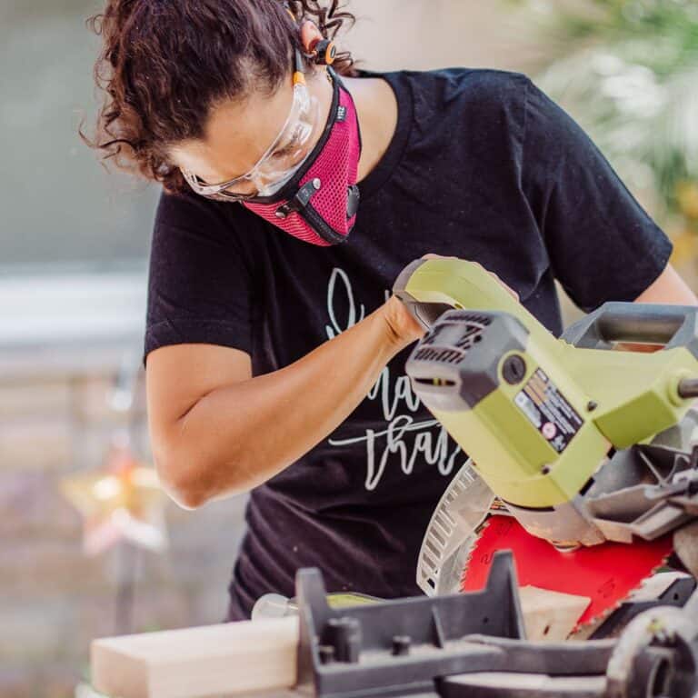 Woman using a miter saw