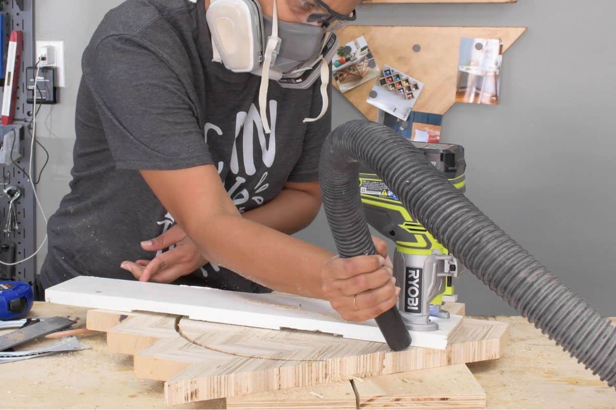 Woman cutting out a circle using a router and a circle jig
