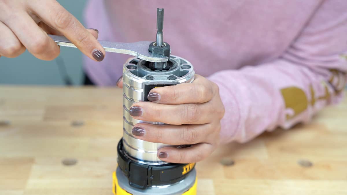 woman installing a bit into the router