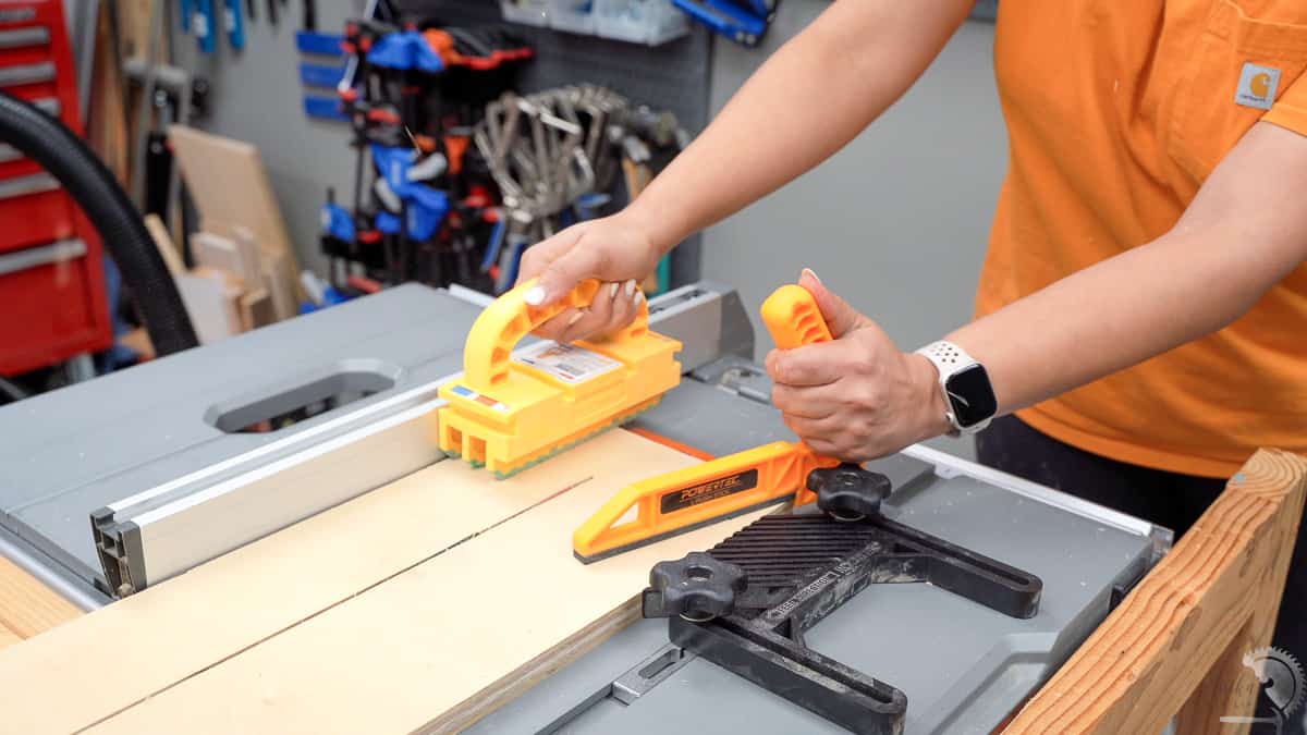 making a rip cut on a table saw using safety devices