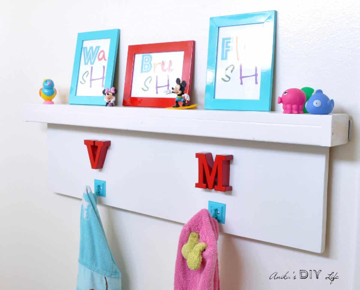 Floating bathroom shelf with towel hooks