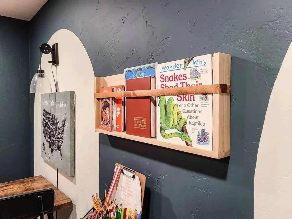 Wood magazine shelf with leather strap to hold magazines or books in place