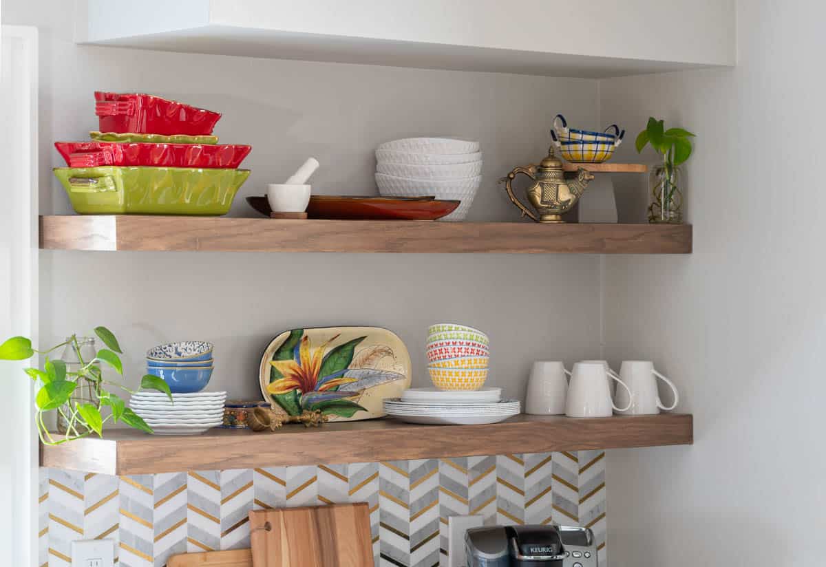 Floating shelves in the kitchen with dishes and decor