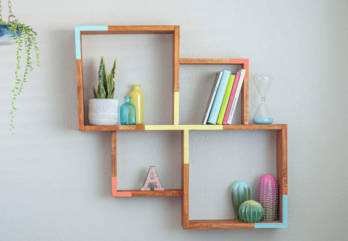 Simple wall shelf made with wood and painted with pink, yellow and blue accents