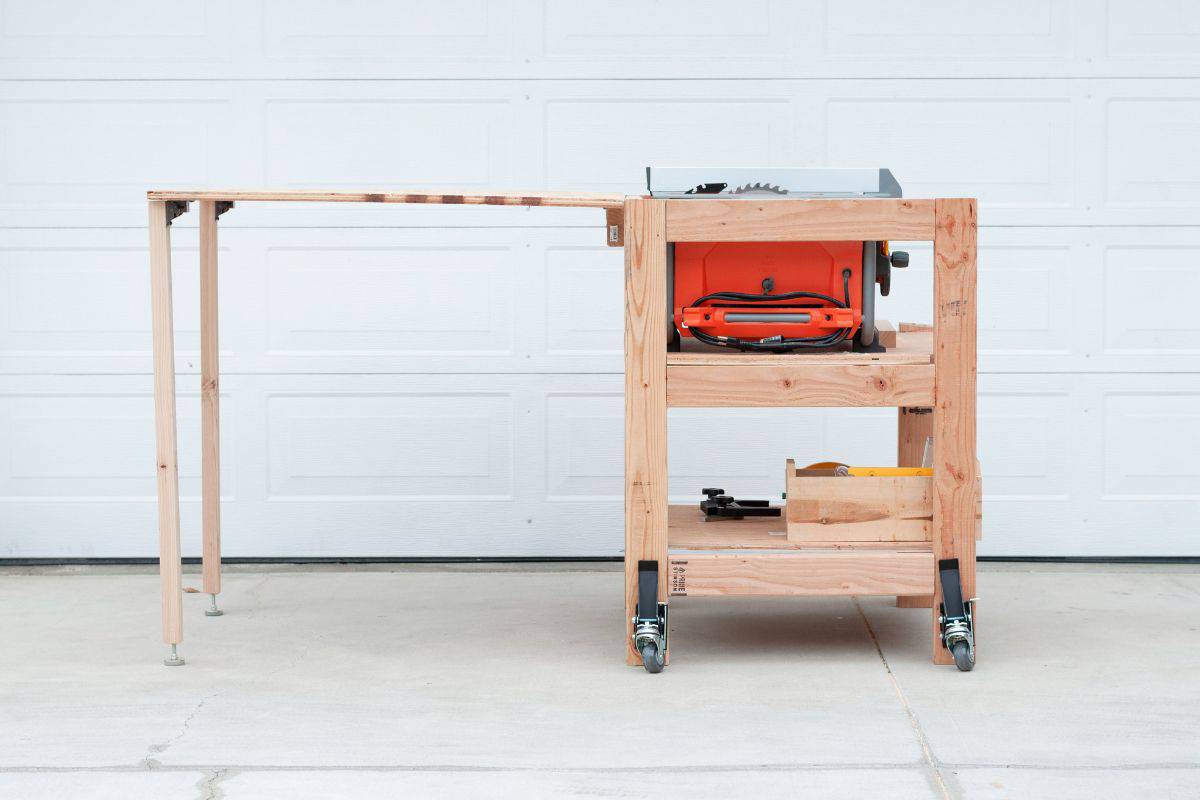 A table saw stand with a folding outfeed table.