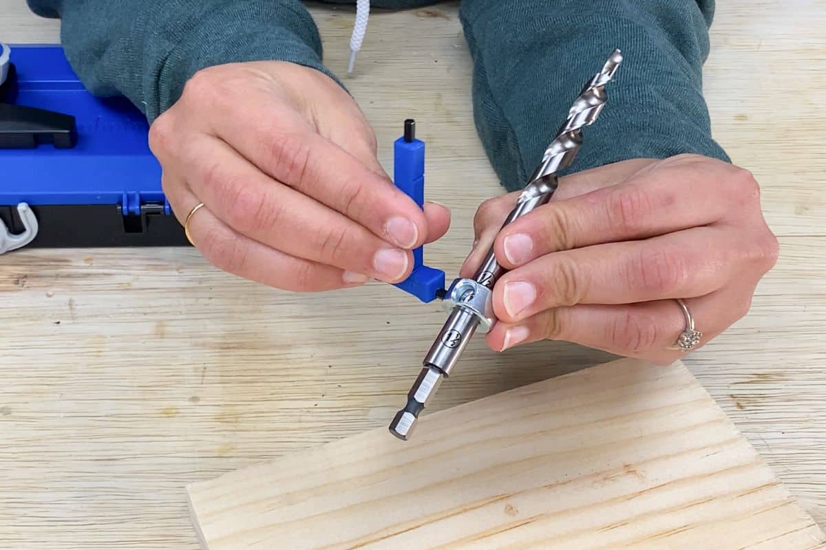 woman setting drill bit collar on the pocket hole bit