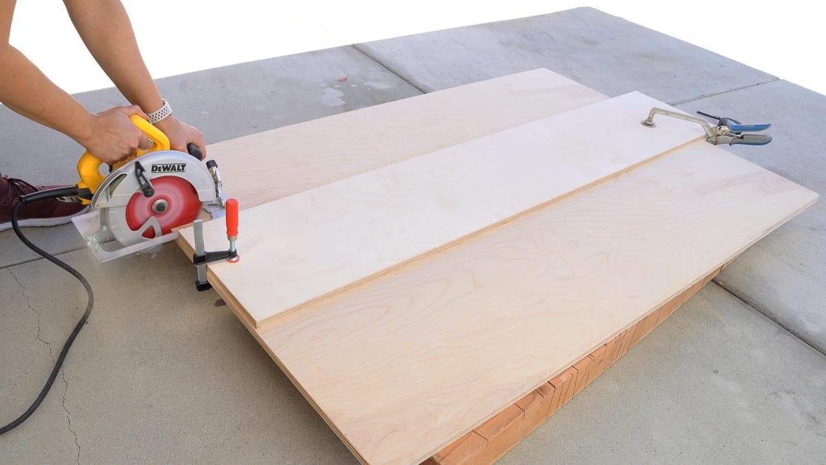 woman cutting plywood using a circular saw