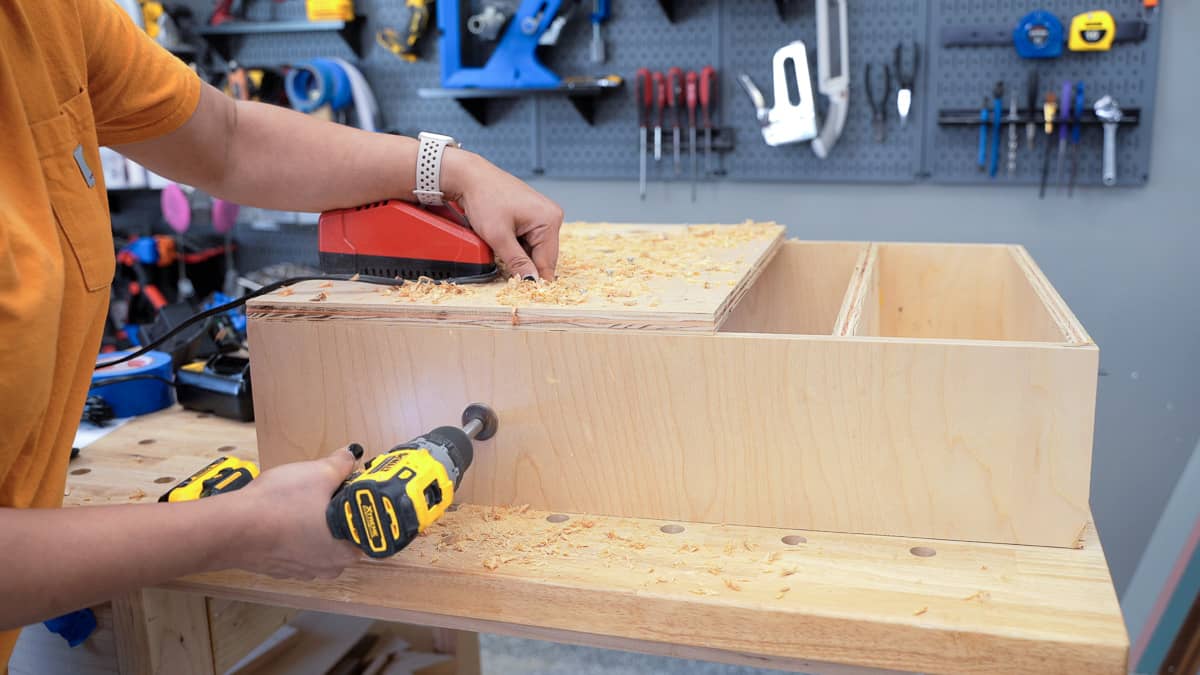 Making hole on the side of the cabinet for the power strip cord