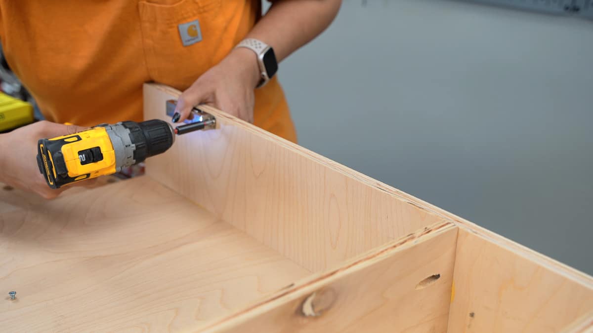 Attaching a magnetic latch to the battery charging station.