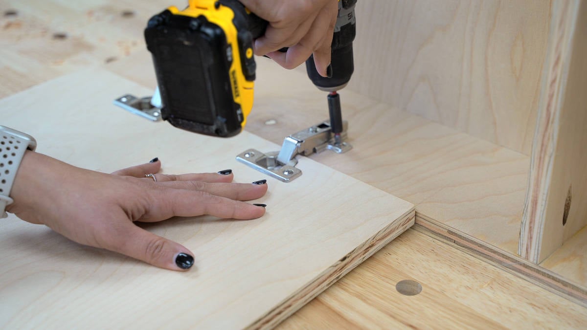 Attaching the hinges on the door for the battery charger