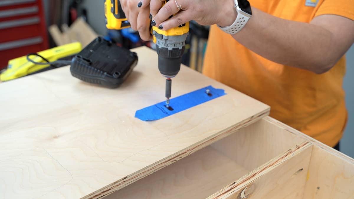 Attaching battery charger to the door of the battery charging cabinet