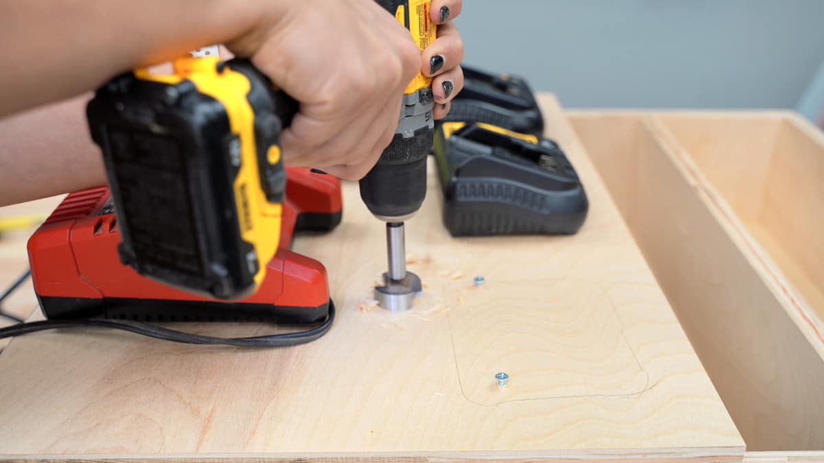 Making holes in the battery charging station for the cords to pass through
