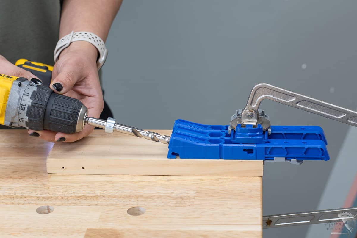 woman making pocket holes using a Kreg 320