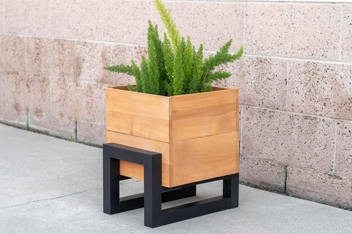 brown and black DIY Modern planter box with plant in front of wall