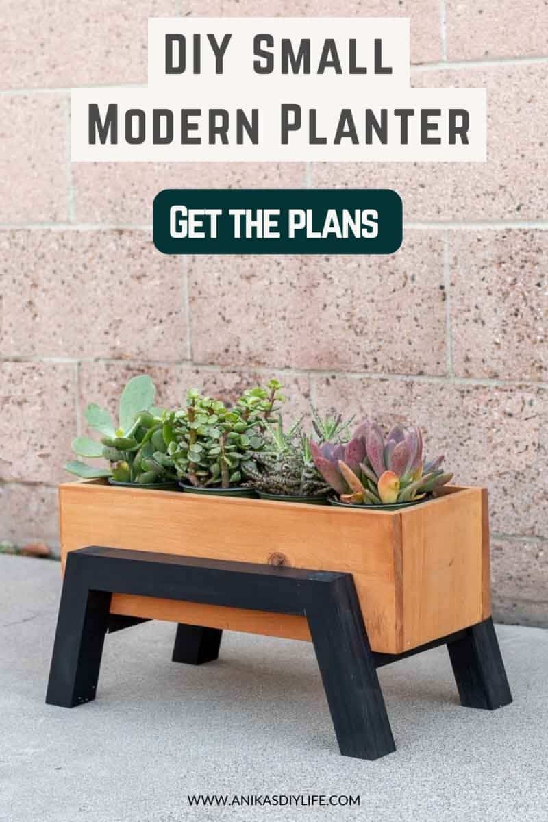 small wood planter box with succulents in front of a wall with text overlay