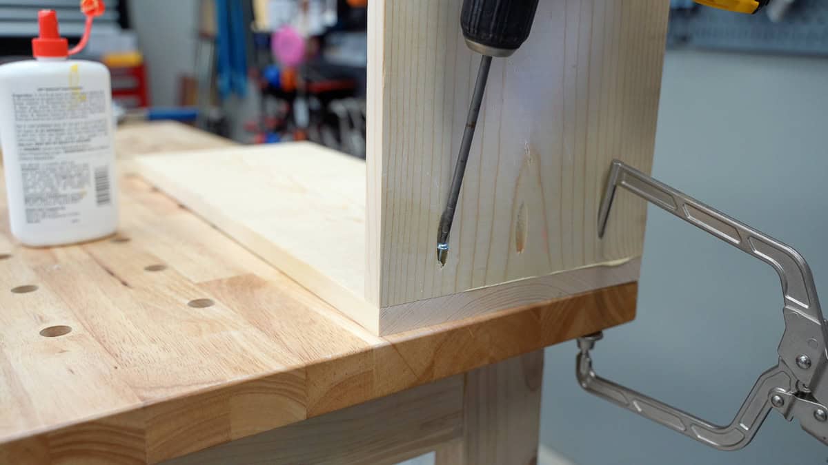 attaching the bottom shelf to the side to make a planter stand