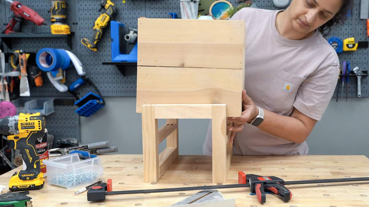 anika adding the planter box into the stand