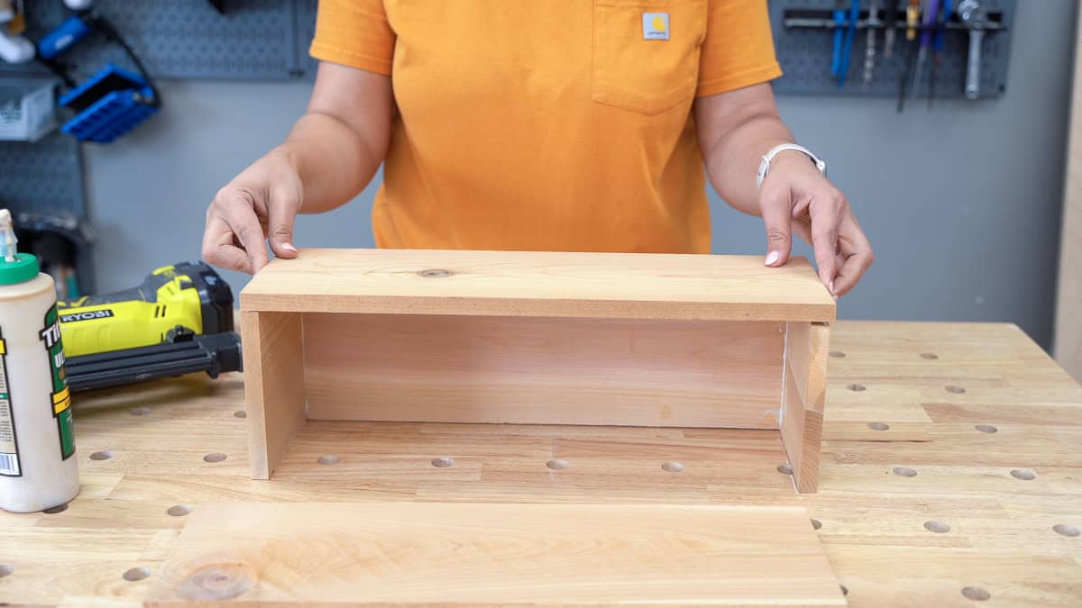 Attaching the long cedar board to build the small wood planter
