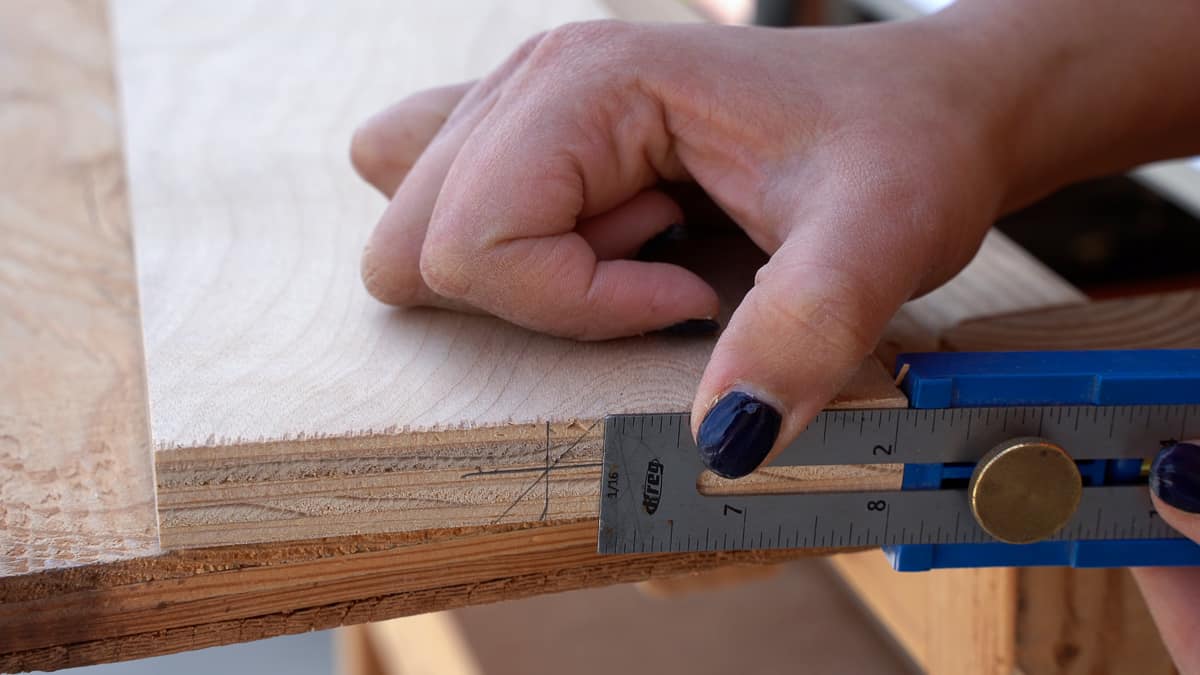 Measuring the distance of the 45-degree mark to set up the table saw fence