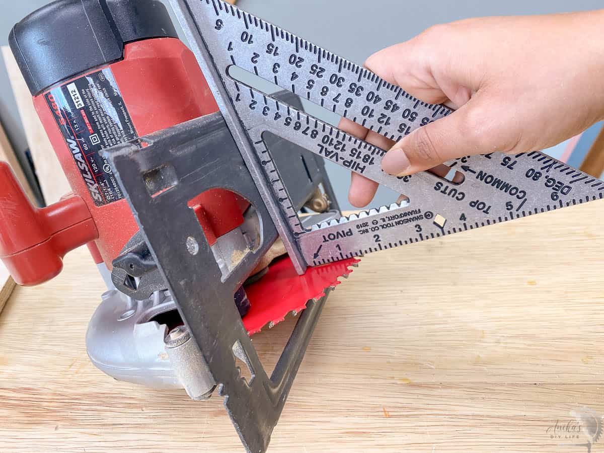 checking the alignment of the circular saw blade with a speed square