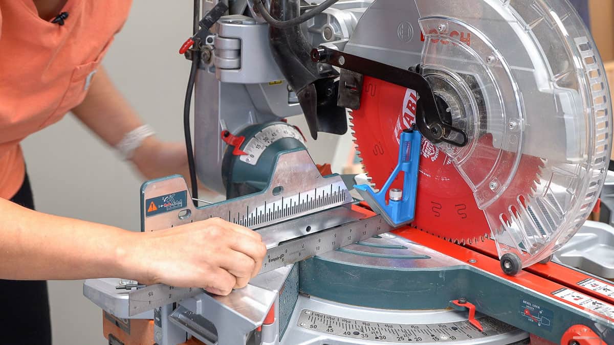 woman aligning a miter saw blade