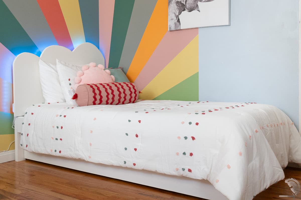 white diy twin bed frame and headboard in a colorful room