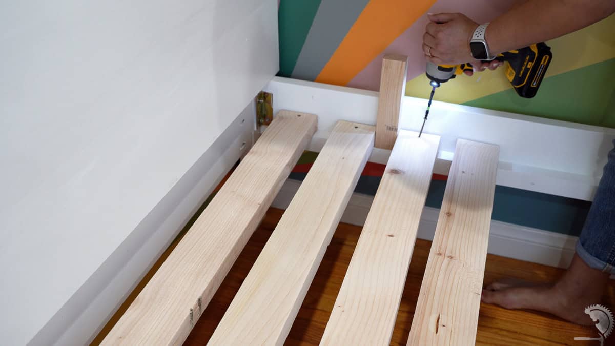 attaching the slats to the bed.