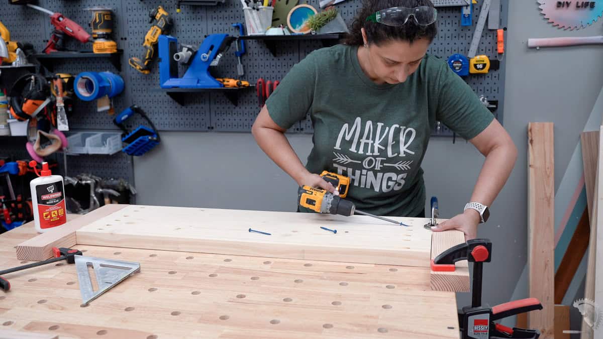 Anika building the footboard using pocket hole screws