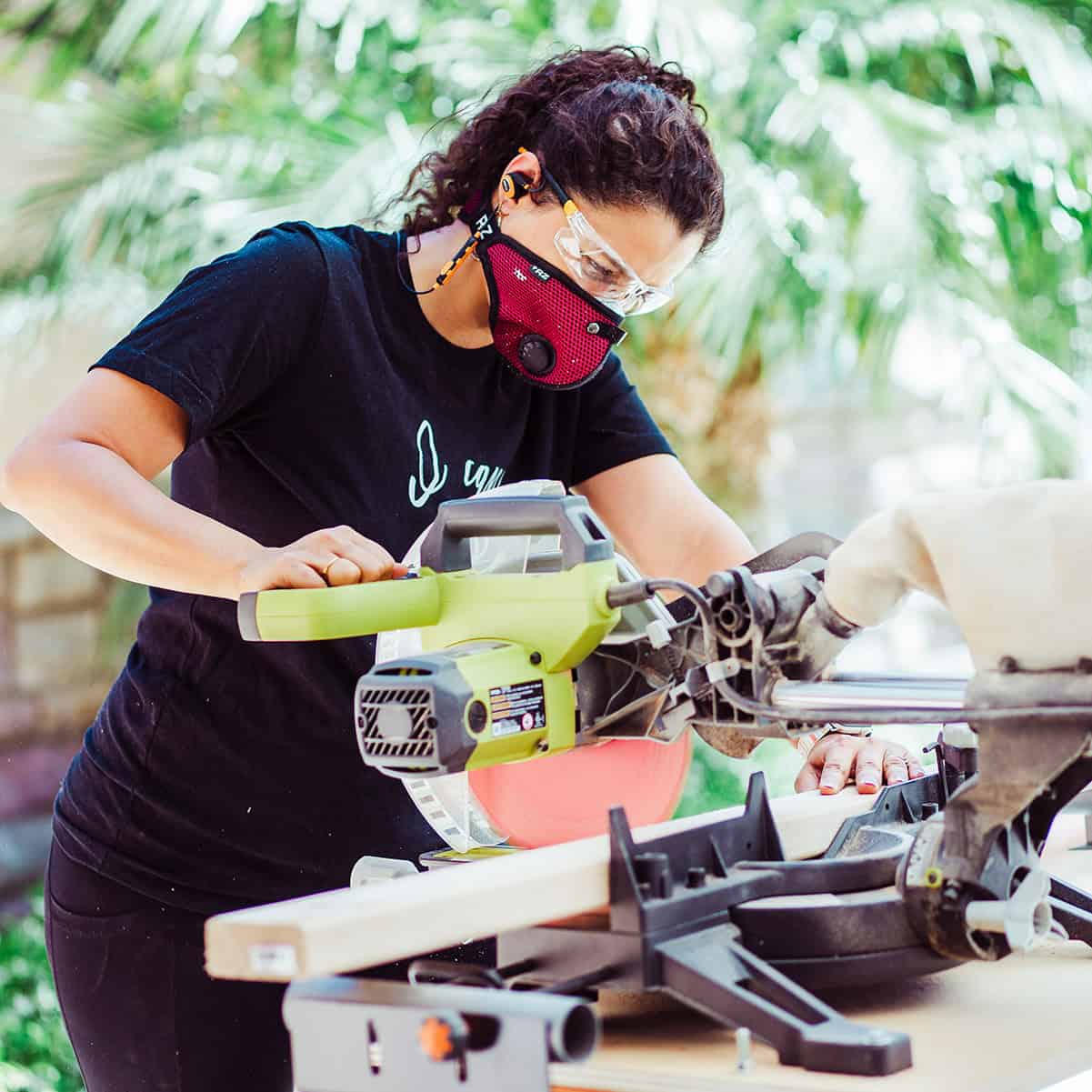 Anika using a miter saw