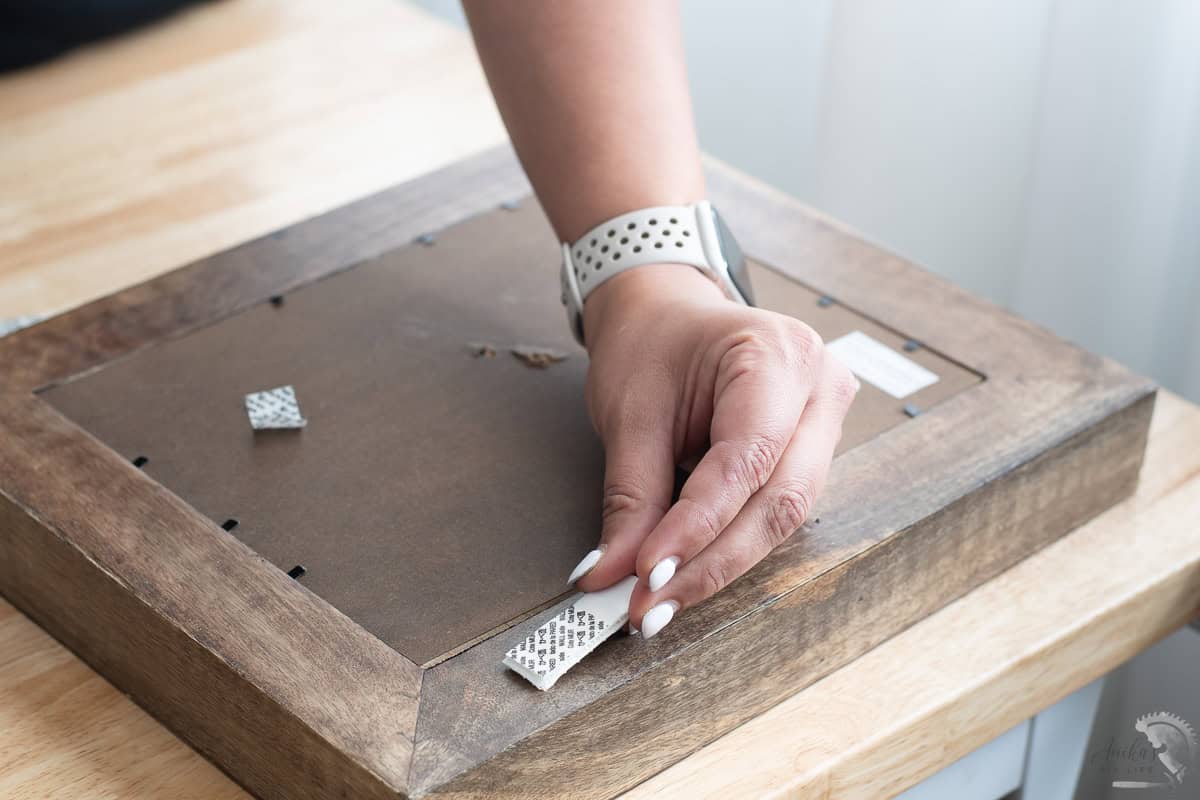 attaching the 3M velcro to the frame for hanging the picture without nails