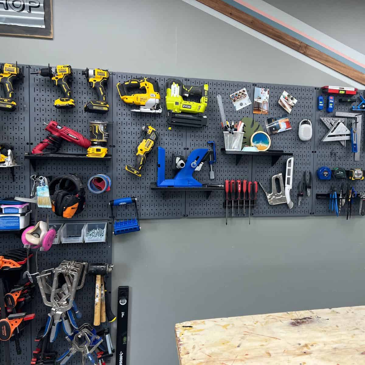 Wall control pegboard in anika's workshop full of tools