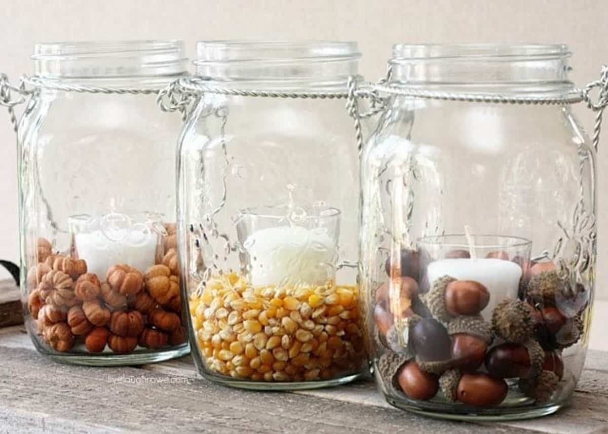3 mason jars with fall floral items and tea light candles