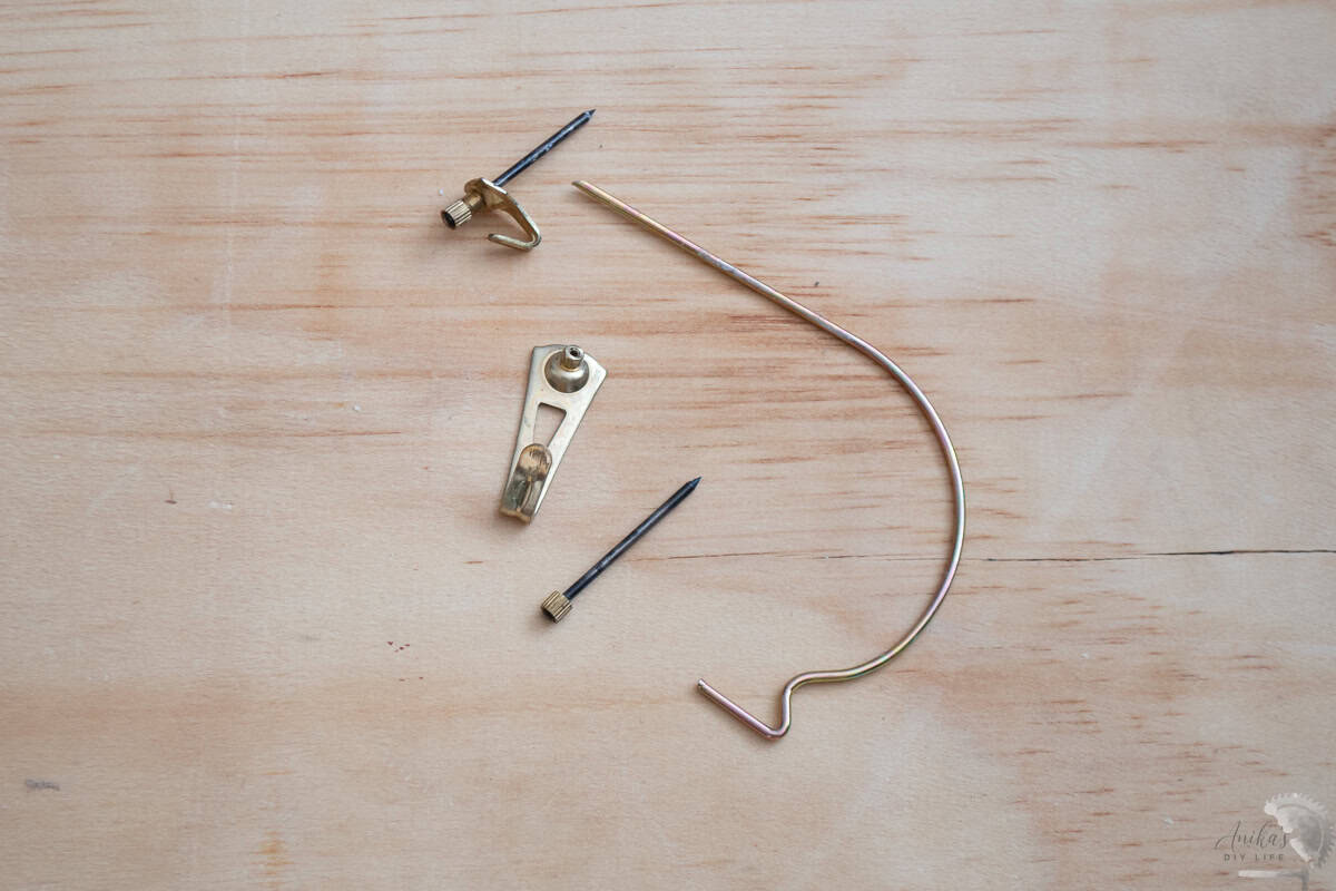 Monkey hooks and picture hangers on the wall.