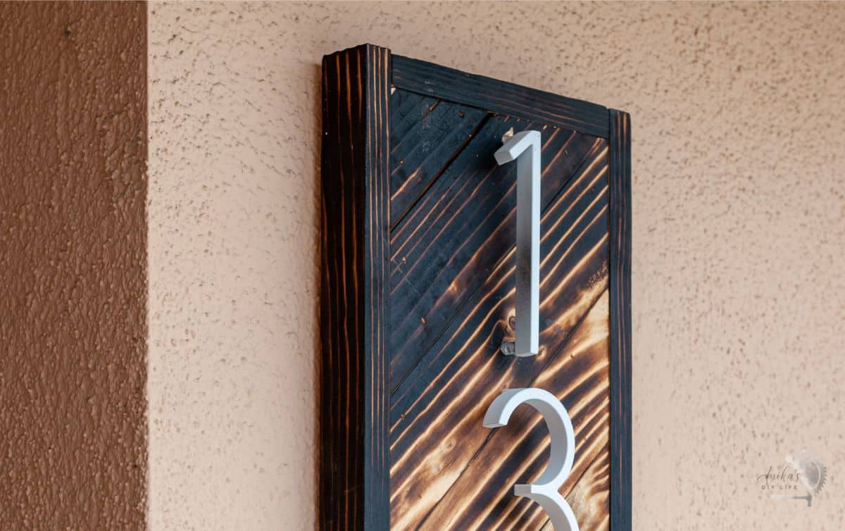 house number sign on stucco - showing how to hang pictures on concrete.