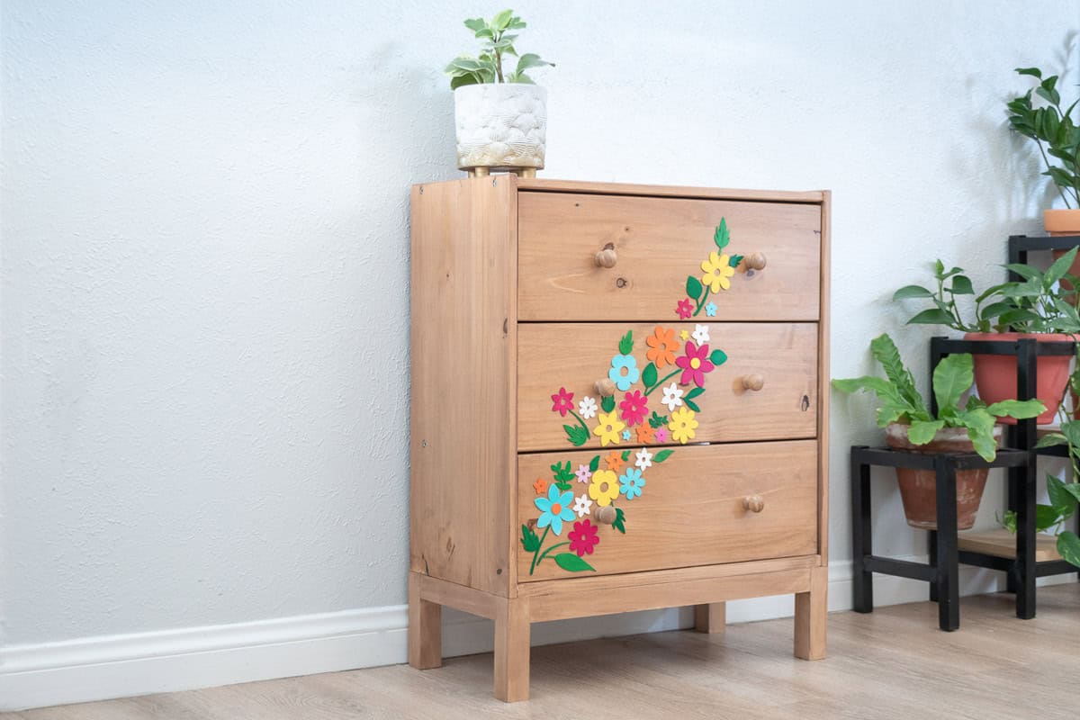 Side view of the Ikea dresser makeover with colorful Cricut wood cutouts