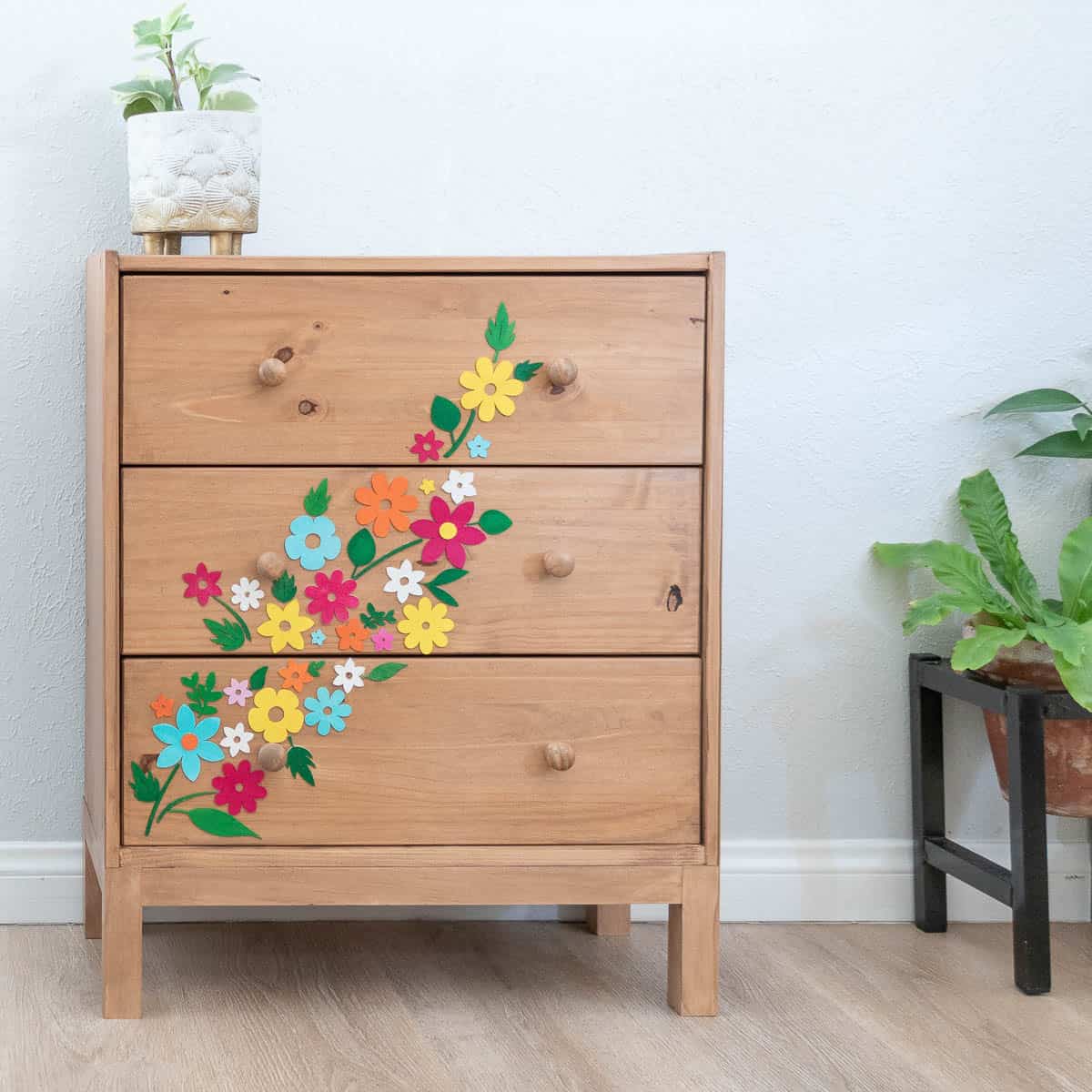 Learn how to transform a basic Ikea Rast dresser into a stylish statement piece with custom Cricut wood cutouts and colorful paint. Easy DIY tutorial for beginners!