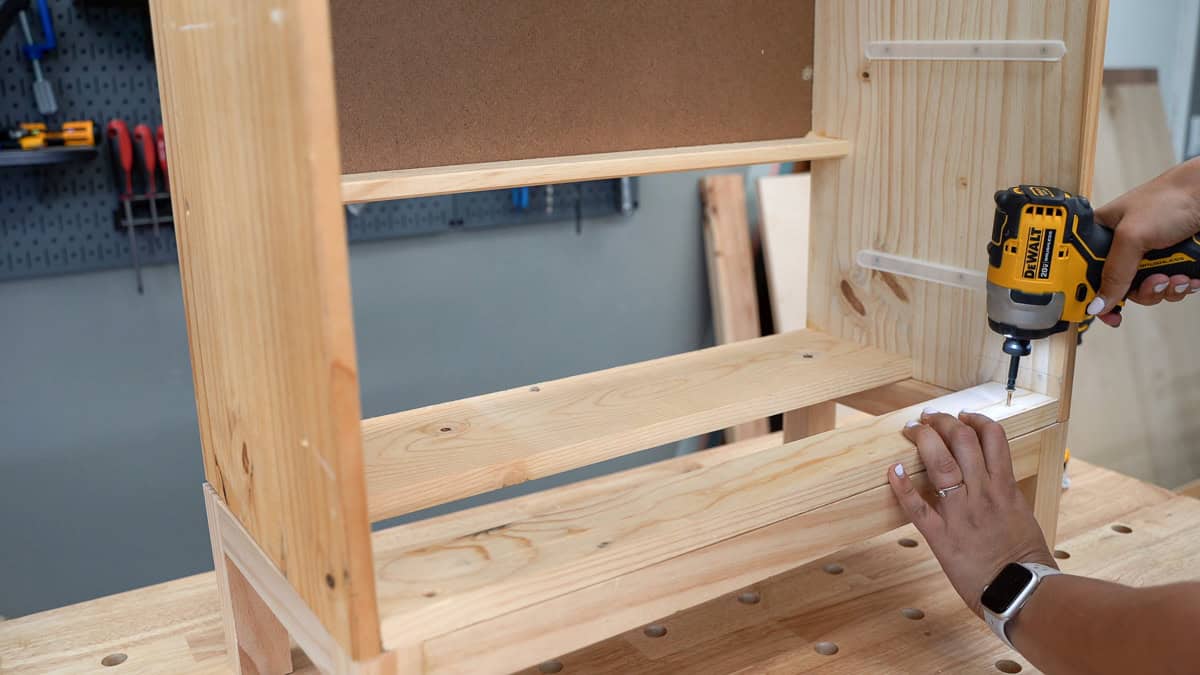 Attaching the legs to the dresser using countersunk screws