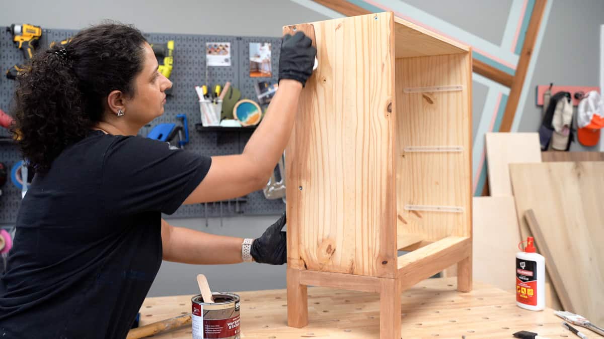 Anika staining the dresser brown