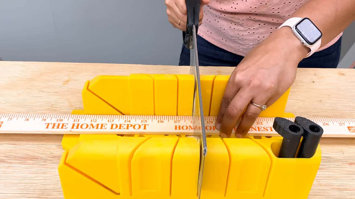 Cutting yardsticks with a miter box and hand saw