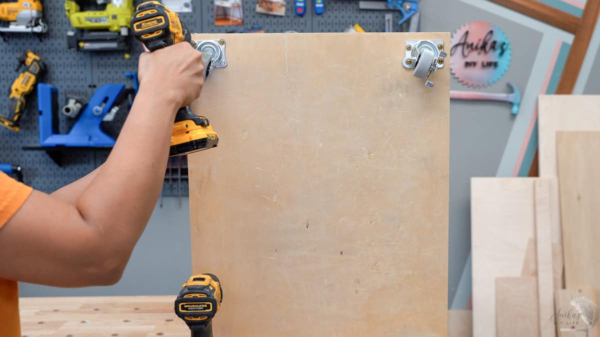 Attaching the caster for the scrap wood cart using a drill