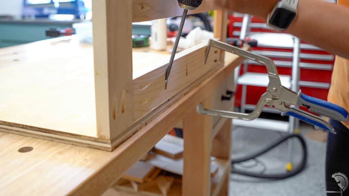 Attaching the frames to the base of the scrap wood cart using pocket hole screws.