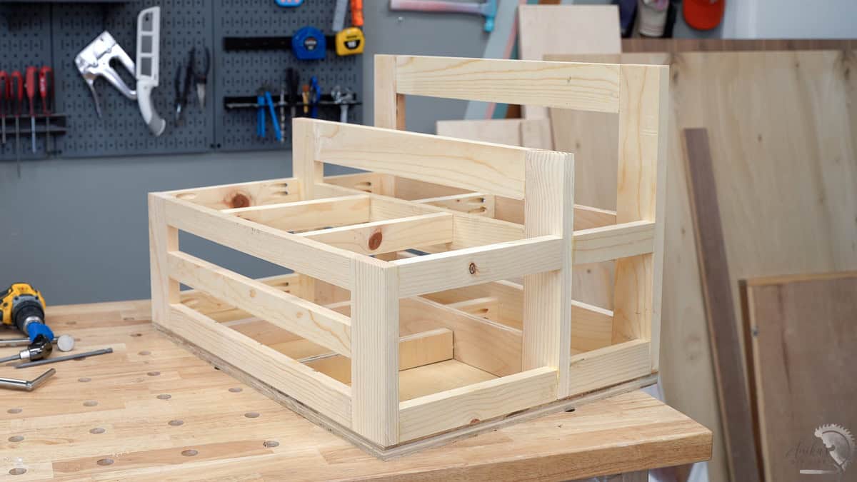 A crate style scrap wood storage cart on the workbench top