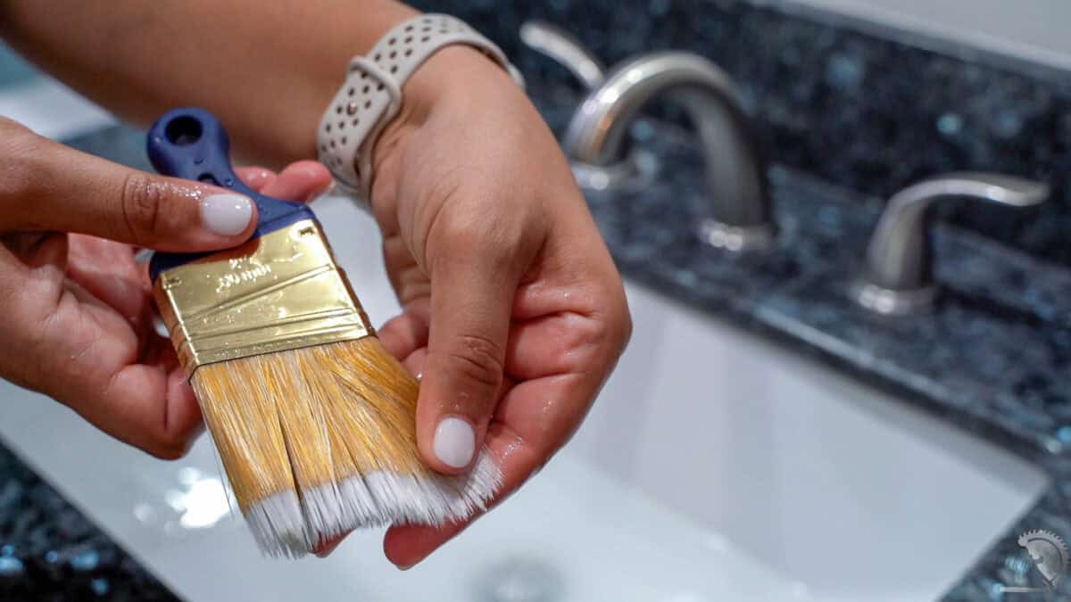 clean paint brush after cleaning the dried paint with rubbing alcohol.