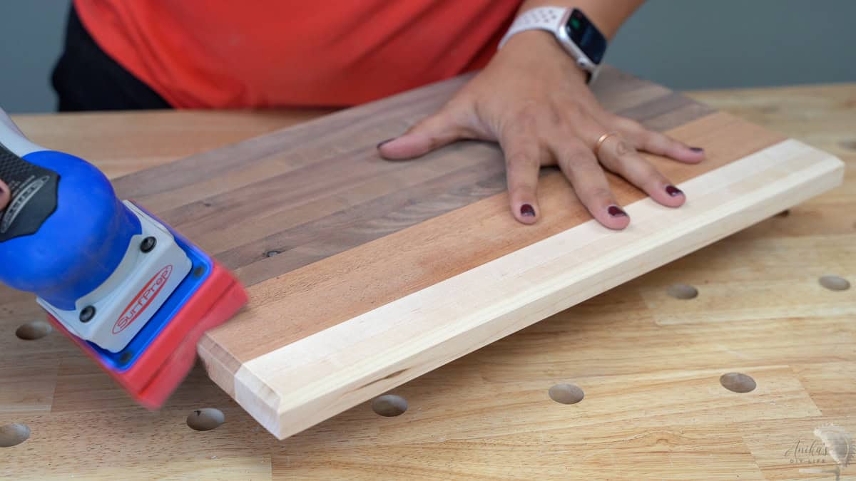 Sanding the edges of the cutting board
