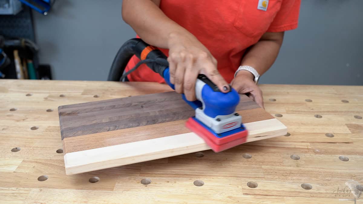Final finish sanding for the cutting board using a sander